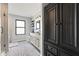 Bathroom with large black cabinet, a single sink, floating shelves and a stand up tiled shower at 1792 Salina Dr, Avon, IN 46123