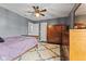 A cozy bedroom with gray walls, a wooden ceiling fan, and coordinating wooden furniture at 1792 Salina Dr, Avon, IN 46123