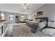 Bright bedroom with a ceiling fan, gray walls, a seating area, and two plush rugs at 1792 Salina Dr, Avon, IN 46123