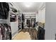 Walk-in closet featuring custom shelving, wood floors, and a modern chandelier at 1792 Salina Dr, Avon, IN 46123