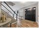 Welcoming entryway with hardwood floors, stairs, and a convenient built-in storage and seating area at 1792 Salina Dr, Avon, IN 46123