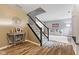 Stylish entryway featuring hardwood floors, staircase, and a glimpse into the adjacent living area at 1792 Salina Dr, Avon, IN 46123