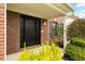 Welcoming front entrance features a black door, brick accents, manicured greenery, and covered porch at 1792 Salina Dr, Avon, IN 46123