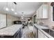 Modern kitchen with granite counters, stainless steel appliances and open concept to the living room at 1792 Salina Dr, Avon, IN 46123