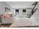 Inviting living room with a comfortable gray sofa and plush pink accents at 1792 Salina Dr, Avon, IN 46123