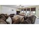 Cozy living room with large sectional, fireplace, and windows with views to the property at 1792 Salina Dr, Avon, IN 46123