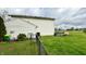 Side view of a home featuring a spacious back yard with a wooden deck, chain link fence, and easy access to outdoor enjoyment at 18017 Gasparilla Ct, Westfield, IN 46062