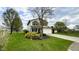 Well-maintained two-story home with a lush front lawn and mature trees at 18017 Gasparilla Ct, Westfield, IN 46062