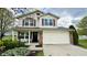 Charming two-story home with white siding, red shutters, and a two-car garage, surrounded by well-maintained landscaping at 18017 Gasparilla Ct, Westfield, IN 46062