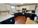 Modern kitchen with stainless steel appliances, two-tone cabinetry, sleek countertops, and ample storage space at 18017 Gasparilla Ct, Westfield, IN 46062