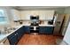 Contemporary kitchen with stainless steel appliances, two-tone cabinetry, bright countertops, and modern fixtures at 18017 Gasparilla Ct, Westfield, IN 46062