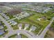 Residential aerial view showcasing a well-planned community with homes, streets, and a neighborhood pond at 18488 Jaden Dr, Westfield, IN 46062
