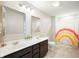 Bright bathroom features a double sink vanity with sleek fixtures and a rainbow shower curtain at 18488 Jaden Dr, Westfield, IN 46062
