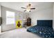 Comfortable bedroom with natural light, a ceiling fan, and a cozy, colorful bedspread and area rug at 18488 Jaden Dr, Westfield, IN 46062