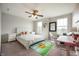 Bright bedroom featuring a comfortable bed, large windows, and a charming workspace with a clear chair at 18488 Jaden Dr, Westfield, IN 46062