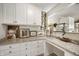 Counter area with granite countertop, drawers, cabinets, and under counter fish tank at 18488 Jaden Dr, Westfield, IN 46062