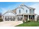 Charming two-story home with blue siding, a three-car garage, and beautifully landscaped front yard at 18488 Jaden Dr, Westfield, IN 46062