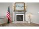 Elegant fireplace with mantle, tile surround, and a decorative piece of art above at 18488 Jaden Dr, Westfield, IN 46062