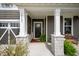Welcoming front porch with stone pillars, a bench, and attractive landscaping details at 18488 Jaden Dr, Westfield, IN 46062
