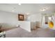 Hallway with light colored carpet and walls, decorated with wall art at 18488 Jaden Dr, Westfield, IN 46062