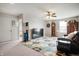 Living room with a comfy couch, fan, and colorful rug at 18488 Jaden Dr, Westfield, IN 46062
