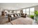 Spacious living room featuring a large sectional couch, windows, and open to the kitchen at 18488 Jaden Dr, Westfield, IN 46062