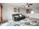 A black couch with white pillows sits atop a colorful rug with a floor lamp next to it at 18488 Jaden Dr, Westfield, IN 46062