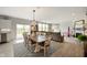 Open-concept living space with a fireplace, dining area, and seamless flow to the outdoors at 18488 Jaden Dr, Westfield, IN 46062