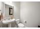 Stylish powder room featuring a pedestal sink, modern fixtures, and a decorative mirror at 18488 Jaden Dr, Westfield, IN 46062