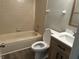 Bright bathroom with a toilet, bathtub, and vanity featuring a wood-finish cabinet and sleek sink at 1959 Crystal Bay East Dr, Plainfield, IN 46168