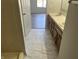Bathroom featuring dual sinks, a wood vanity, and marble-style flooring, creating a luxurious space at 1959 Crystal Bay East Dr, Plainfield, IN 46168