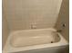 A clean, well-maintained bathtub with classic tile surround, chrome fixtures and a built in soap holder at 1959 Crystal Bay East Dr, Plainfield, IN 46168