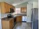 Cozy kitchen with stainless steel appliances, wood cabinets, and a view of the backyard at 1959 Crystal Bay East Dr, Plainfield, IN 46168