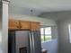 Bright kitchen featuring stainless steel refrigerator and wood cabinets at 1959 Crystal Bay East Dr, Plainfield, IN 46168