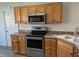 Kitchen featuring stainless steel appliances, wood cabinets, and laminate countertops at 1959 Crystal Bay East Dr, Plainfield, IN 46168