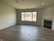 Bright living room featuring a fireplace and a large window overlooking the lake at 1959 Crystal Bay East Dr, Plainfield, IN 46168