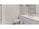 A white bathroom features a vanity, mirror, toilet, and a shower curtain at 2075 Sea Hero Ct, Indianapolis, IN 46234