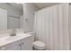 A neutral bathroom has a toilet, vanity, sink, and a shower with a white curtain at 2075 Sea Hero Ct, Indianapolis, IN 46234