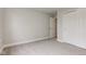 A bedroom has neutral carpet and paint with a closet with sliding doors and an open doorway at 2075 Sea Hero Ct, Indianapolis, IN 46234