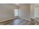 A bright bedroom is showcased with wood flooring and a window at 2075 Sea Hero Ct, Indianapolis, IN 46234