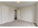 A bedroom has neutral carpet and paint with a closet with sliding doors and an open door to the hallway at 2075 Sea Hero Ct, Indianapolis, IN 46234