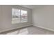 A bedroom has neutral carpet and paint with a view of the deck and back yard through a large window at 2075 Sea Hero Ct, Indianapolis, IN 46234