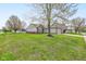 Spacious yard view of the exterior with a two car garage, vinyl siding, and well maintained lawn at 2075 Sea Hero Ct, Indianapolis, IN 46234