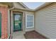 Close up of the covered front porch featuring a green door, exterior lights, and brick accents at 2075 Sea Hero Ct, Indianapolis, IN 46234