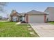 Charming single Gathering home with a two-car garage, red brick accents, and well-maintained landscaping at 2075 Sea Hero Ct, Indianapolis, IN 46234