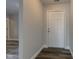 Bright hallway features new wood-look tile flooring with a six panel front door at 2075 Sea Hero Ct, Indianapolis, IN 46234