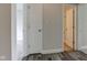 Hallway with wood floor and gray wall with two white doors and a view of a carpeted bedroom and a bathroom at 2075 Sea Hero Ct, Indianapolis, IN 46234