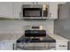 New stainless steel appliances including range, microwave, and white quartz countertops at 2075 Sea Hero Ct, Indianapolis, IN 46234