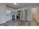 Bright kitchen with stainless appliances, white cabinets, and wood look tile flooring at 2075 Sea Hero Ct, Indianapolis, IN 46234
