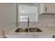New modern, stainless sink with a pull down faucet and white quartz countertops at 2075 Sea Hero Ct, Indianapolis, IN 46234